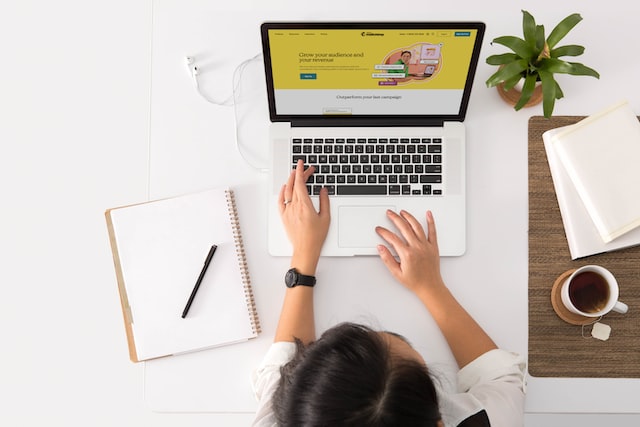 A woman browsing a website on her laptop