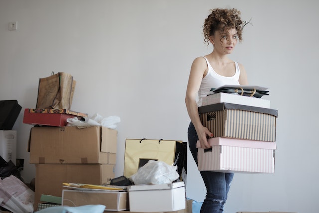 A girl moving boxes in a house