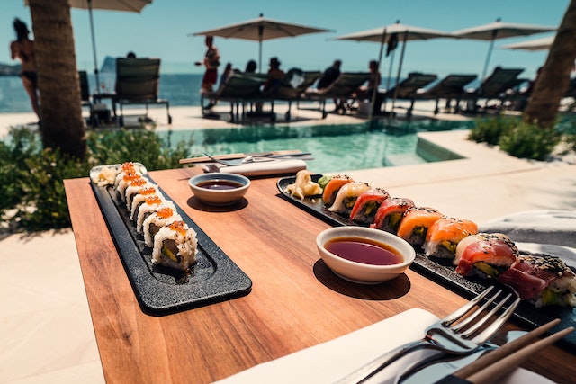 An outdoor open kitchen near swimming pool