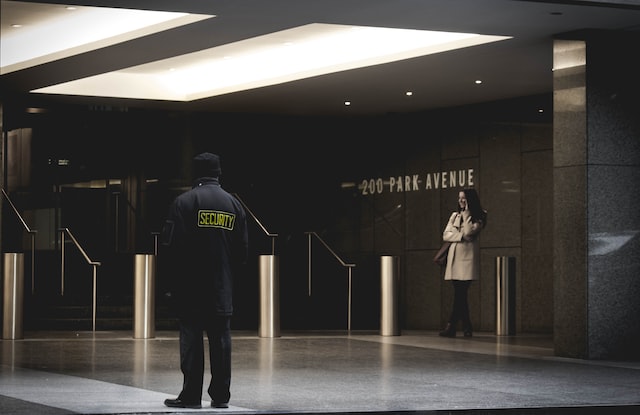 A security guard outside entrance of a venue